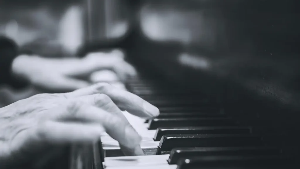 Hands on a piano keyboard