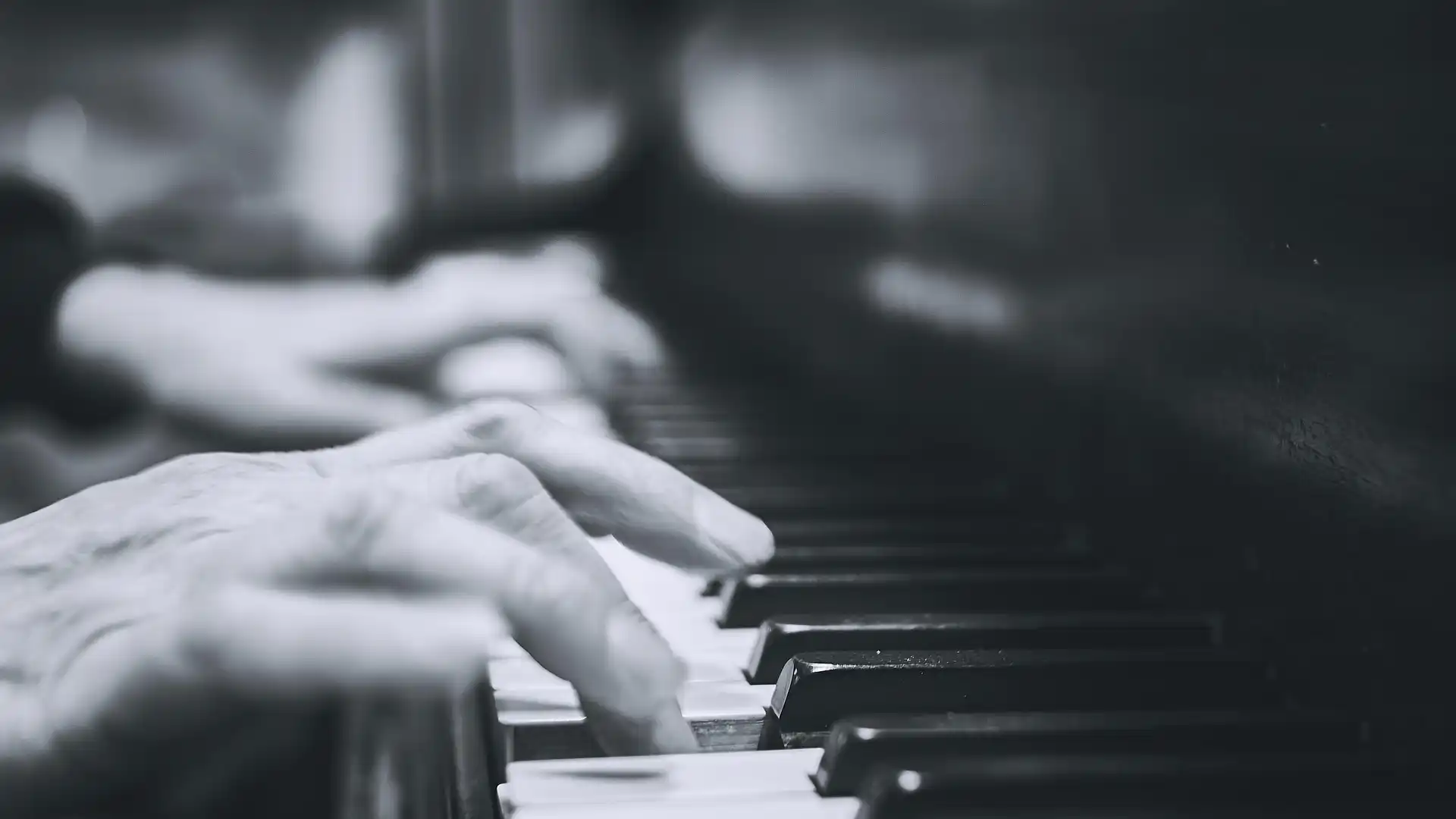 Hands on a piano keyboard